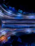 Long Exposure Night Photo Of Traffic On A Major Freeway Interchange Viewed From Overhead