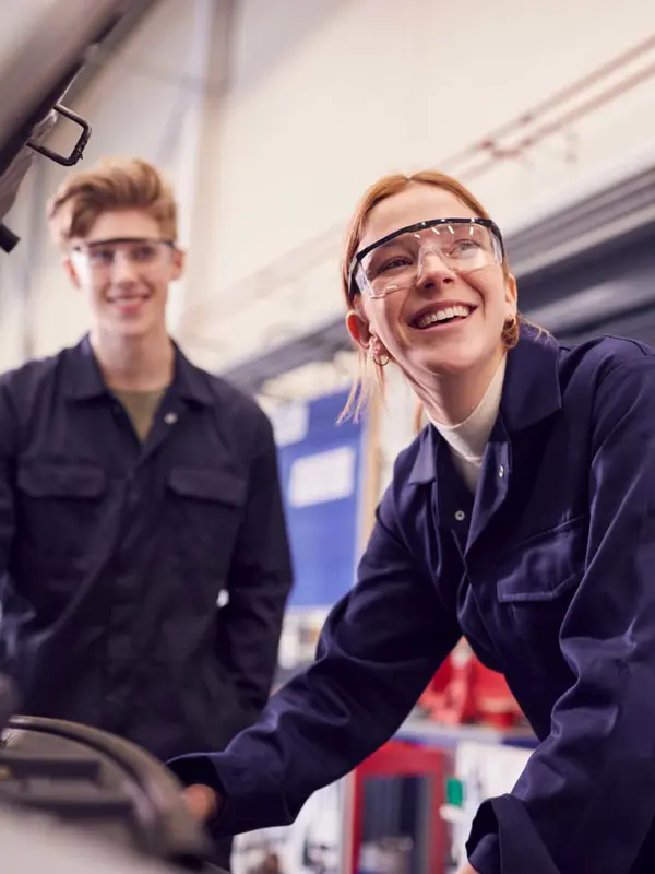 Young Smiling Mechanics In A Workshop
