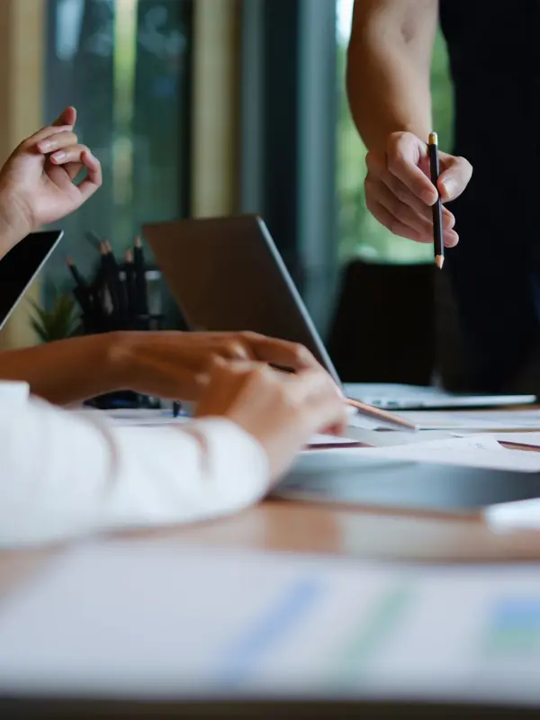 People Discussing Documents On An Office Table