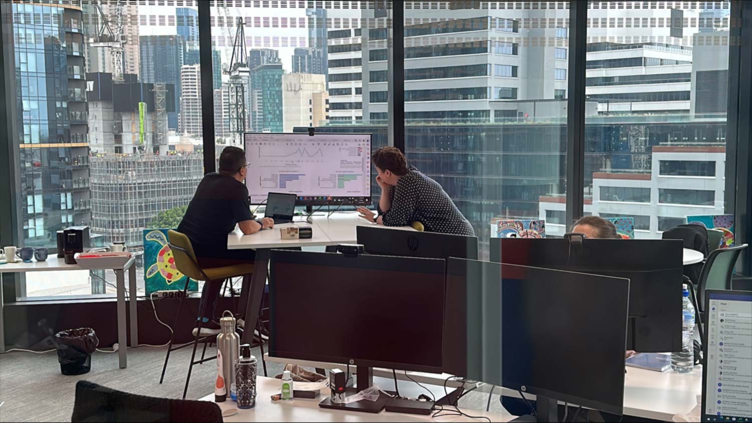 Or Team Reviewing Onscreen Data In High Rise Inner City Office Location