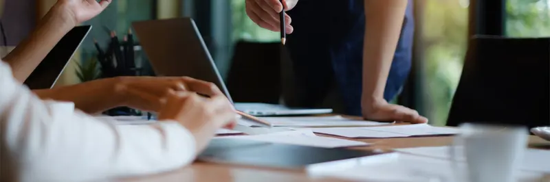 People Discussing Documents On An Office Table