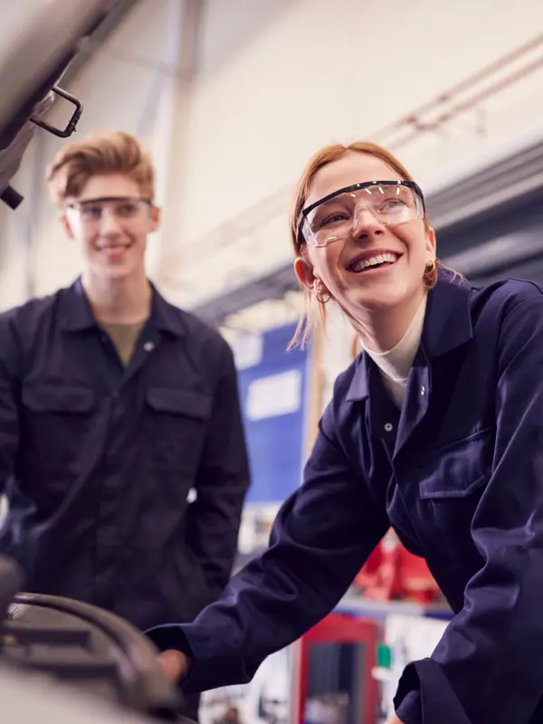 Young Smiling Mechanics In A Workshop