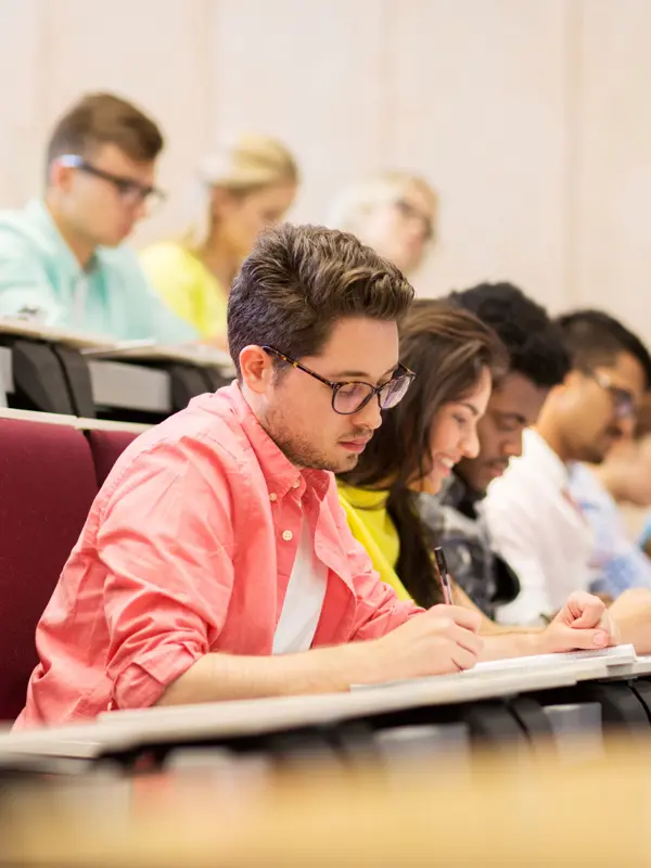 People Sitting In A Lecture Taking Notes