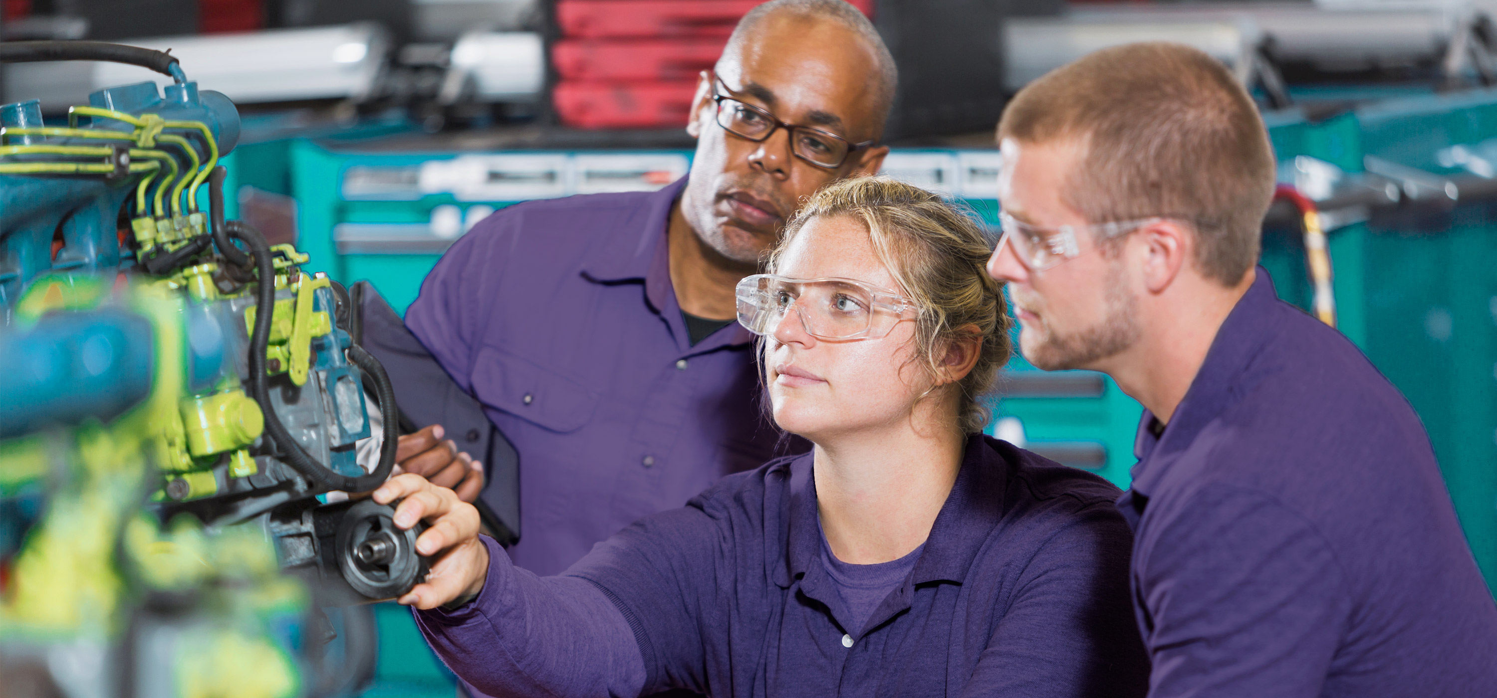 Three Workers Testing An Engine
